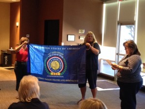 (L  to R): Mary Thurston, Mary Woolford, & Carol Gilmore present the Vietnam War 50th Flag to the chapter. 