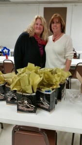  Mary Woolford (dark sweater) and Linda Nardini (light sweater) Chapter members helping to fill the bags.